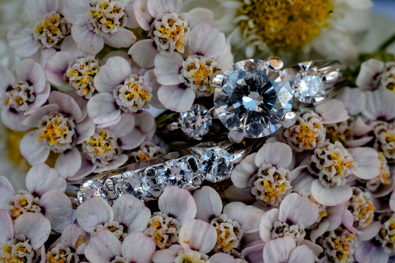 close up shot of wedding rings in wedding flower bouquet.
